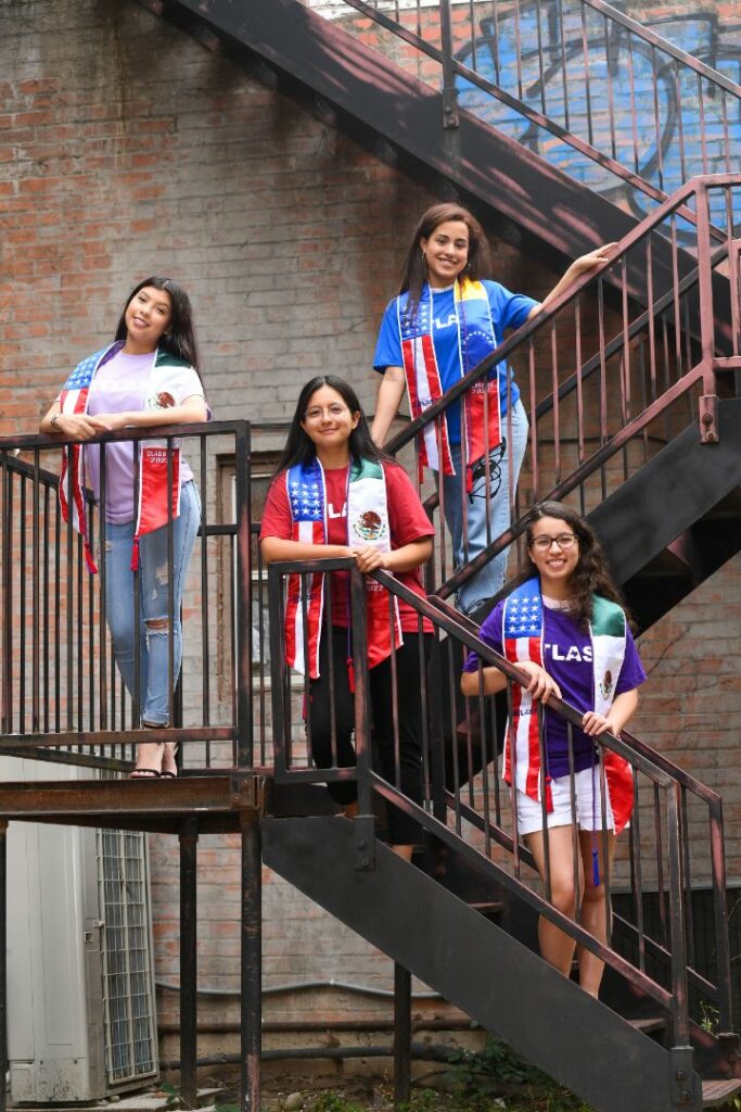 Four Female Latino Students Standing on Stairs Outside ATLAST Nonprofit McKinney Texas.